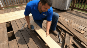 Worker replacing damaged boards during Wood Deck Repair and Maintenance to restore deck strength and appearance.
